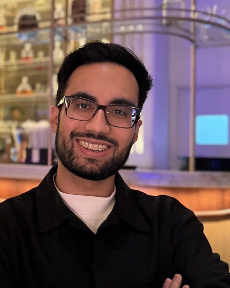 Dr Syed Ali smiling, arms folded